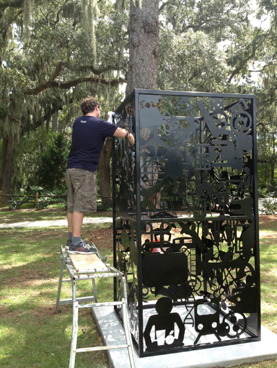 Roane State associate professor of art Bryan Wilkerson installs his piece 