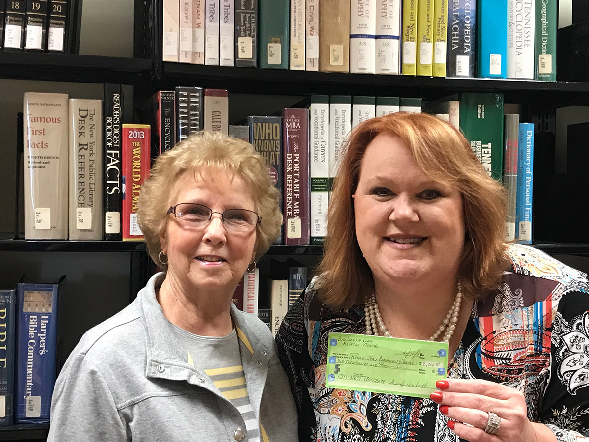 Sharon Wilson, right, director of Roane State's Scott County campus, holds a check representing a $2,000 donation to students at the campus given by volunteers at the Big South Fork Medical Center. Kay Botts, president of the volunteer organization, is at left.