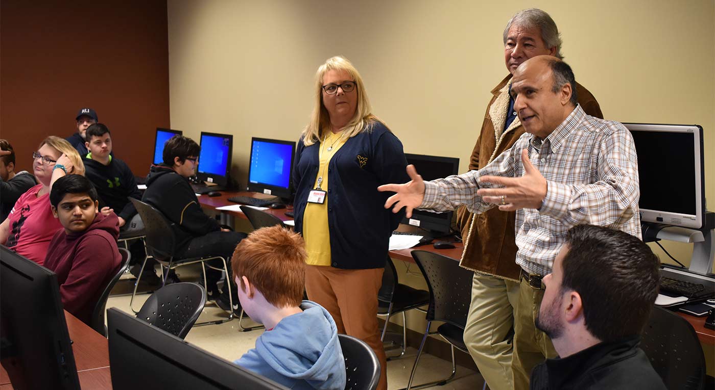 Dr. George Meghabghab, director of Roane State’s Computer Information Technology program, gestures at the start of the college’s second annual cybersecurity competition. Also pictured: Dr. Diane Ward, the college’s vice president for student learning, and Bruce Cantrell, interim dean of mathematics and sciences.