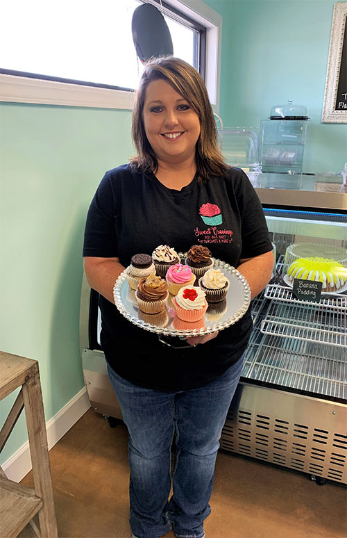 Roane State alumnus Nicole Cravens displays some of the many types of cupcakes she bakes and decorates in her new Fentress County business, Sweet Cravings.