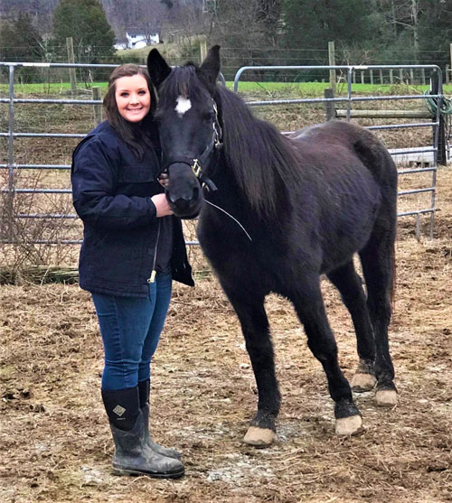 Jacey Queener is shown with one of the horses she tends to on the family farm in Anderson County’s scenic Dutch Valley community.