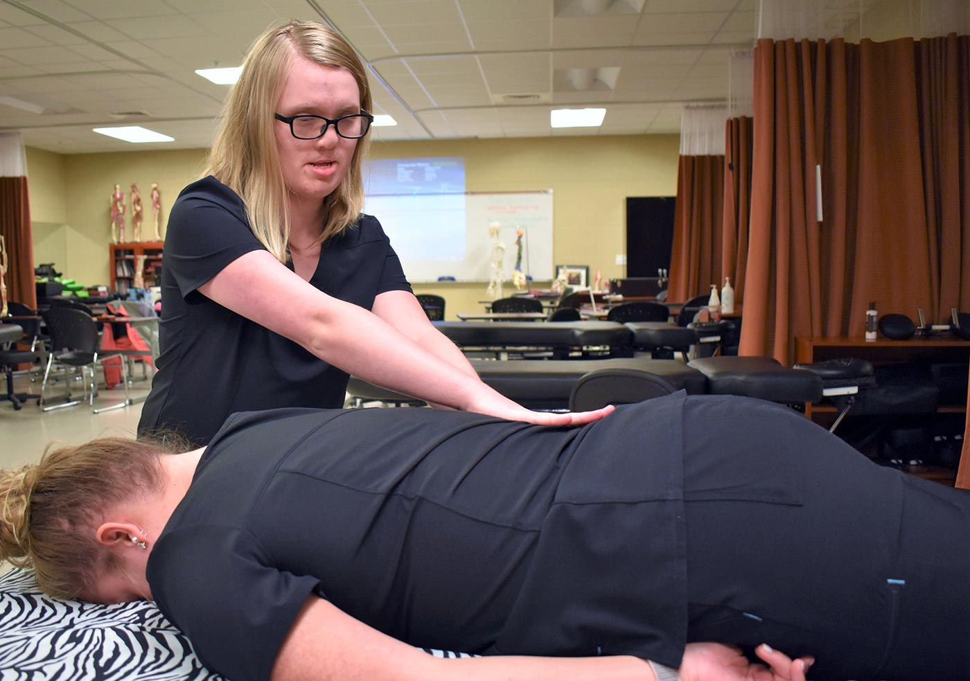 Harley Sharpe practices massage on another student in Roane State Community College’s massage therapy class.