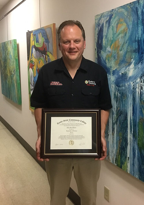 Scott Davis with his associate degree from Roane State Community College.