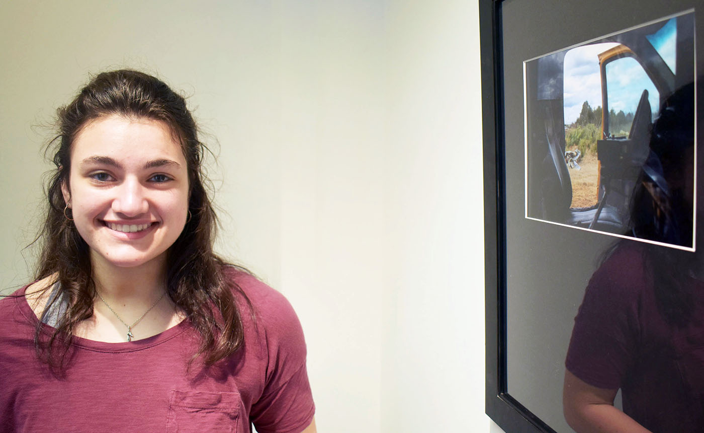 2.	Abigail Ellis, a junior at Oak Ridge High, is shown next to her Best of Show entry in the revived Student Art Show at Roane State.