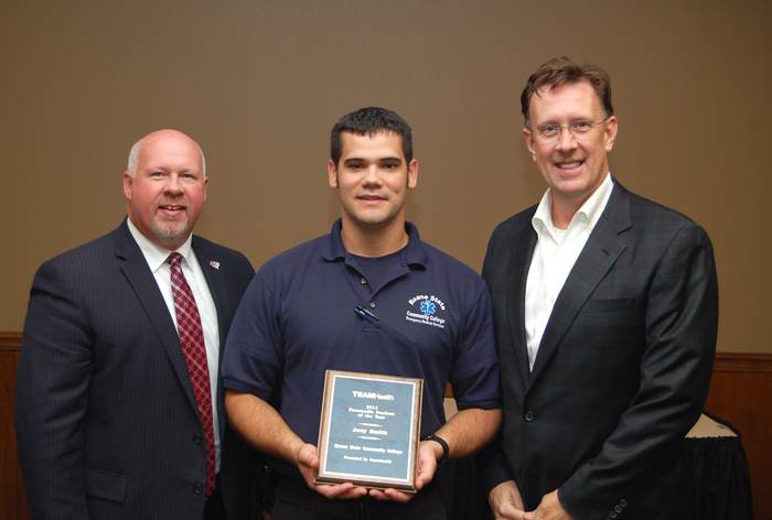 Roane State paramedic student of the year Joey Smith (center) is congratulated by Roane State President Dr. Chris Whaley (left) and Dr. Roger Brooksbank with TeamHealth Emergency Medicine.