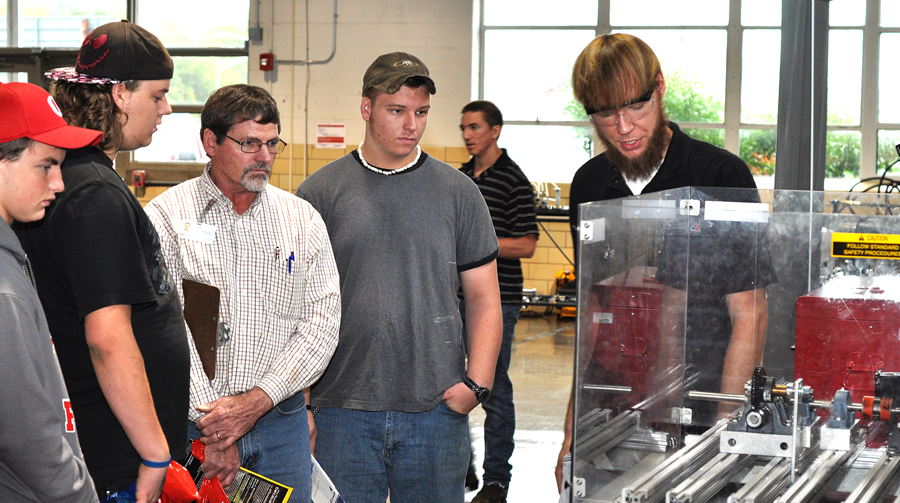 Roane State mechatronics student James Eldridge of Clinton, right, leads a demonstration during Manufacturing Day.