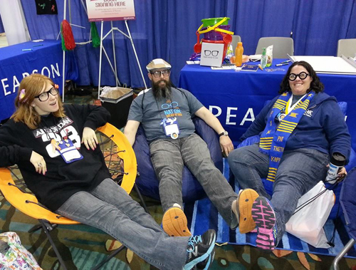Students sitting at booth during convention