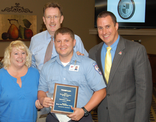 Roane State paramedic student of the year Terry Hicks is congratulated by his mother, Tangiela, Dr. Roger Brooksbank with TeamHealth Emergency Medicine and Roane State paramedic program director David Blevins.