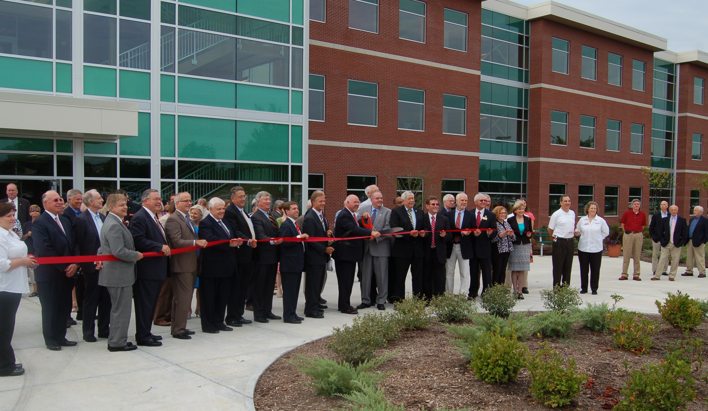 Leaders and officials cut the ribbon for the new building at Oakk Ridge campus.