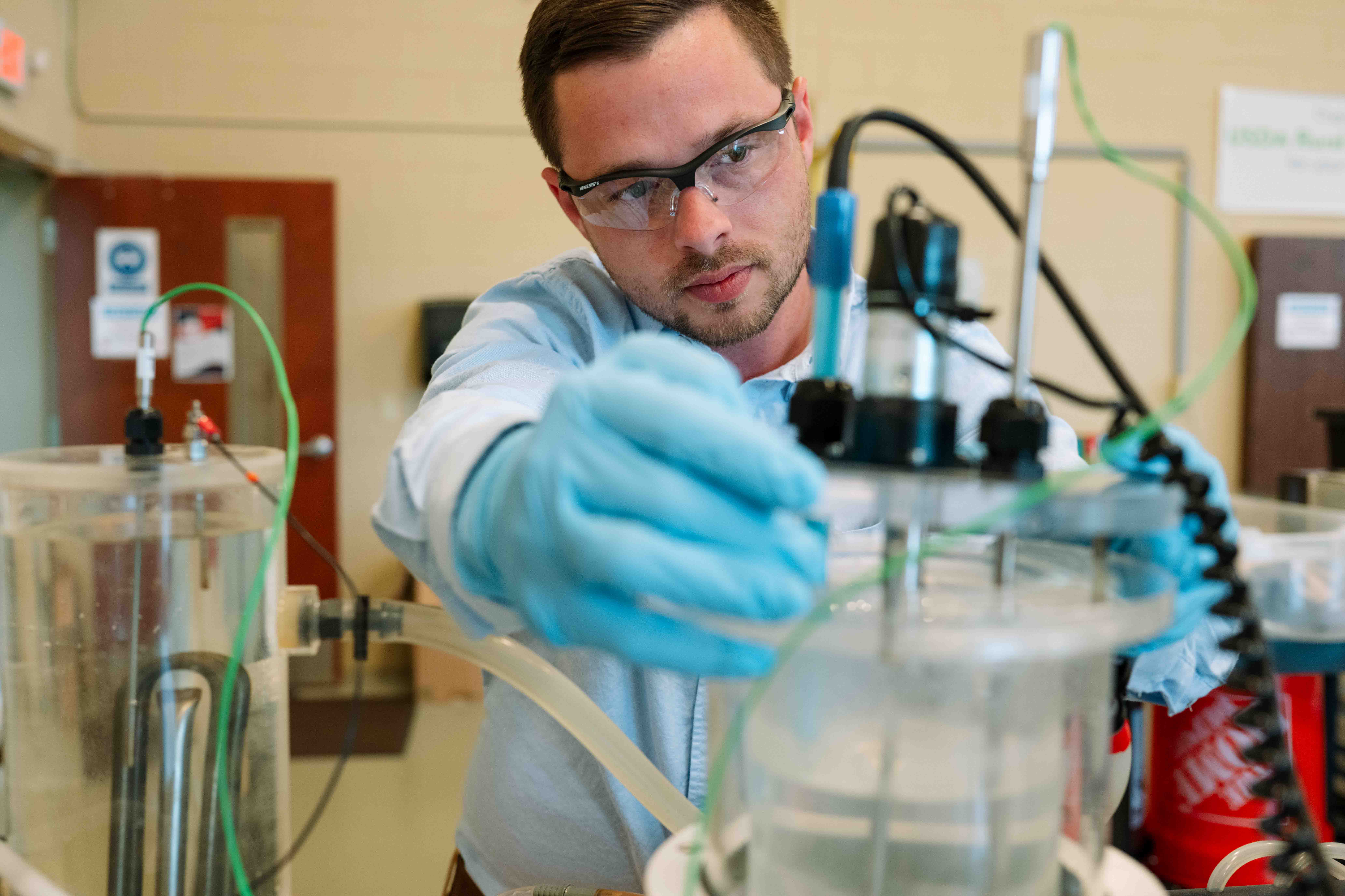 Student working with chemical engineering equipment in a laboratory
