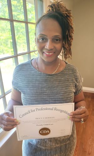 Tracy Herman holding a certificate