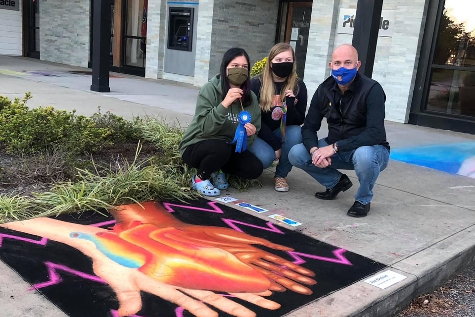 Shows a square of sidewalk and a sponsor's display