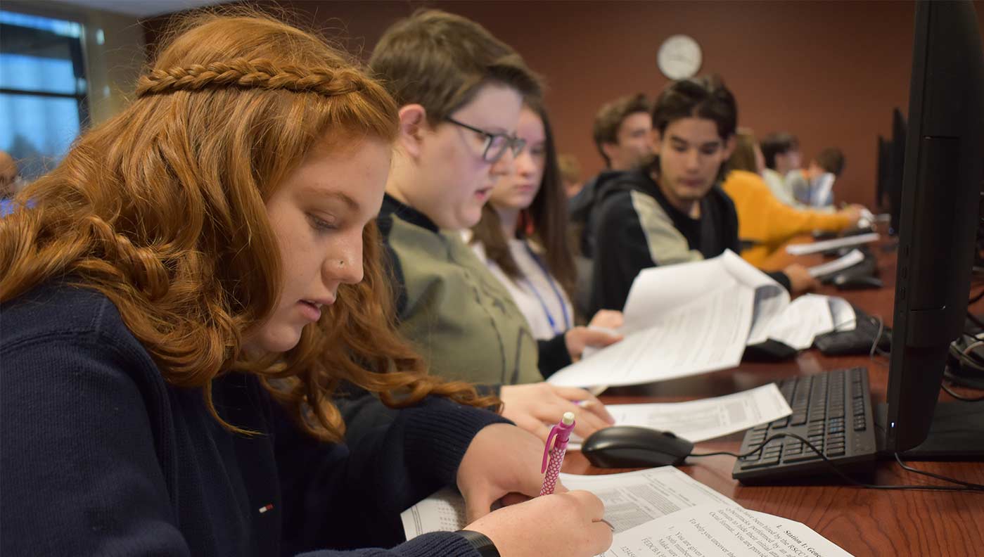 Gracie Davis, a student at Clinton High School, works to unravel a cyber puzzle during the college’s second annual cybersecurity competition.