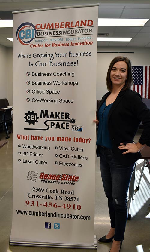 Shannon Johns, founder and owner of Thrive Therapy, is shown with a poster about the Cumberland Business Incubator, where her office is located.