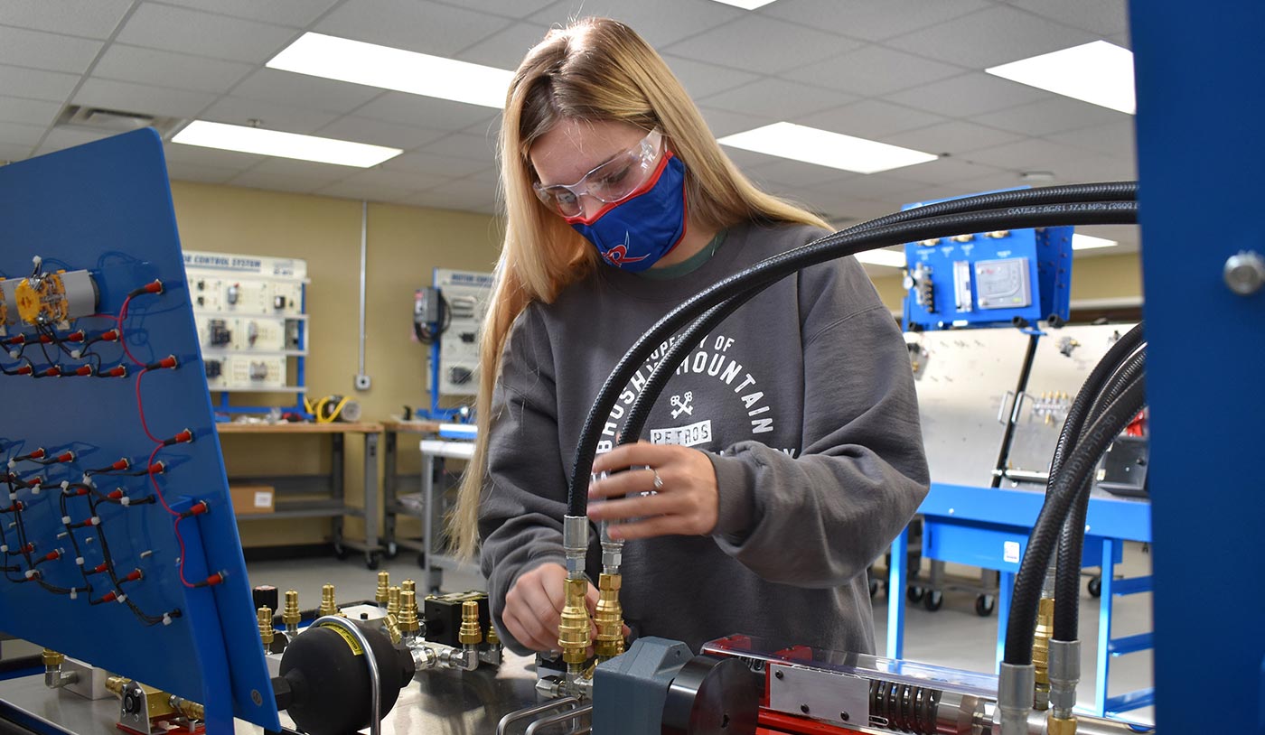 Wartburg Central High student Chloe Jones checks out the hydraulic instrumentation module in the new mechatronics lab in the Learning Center at Roane State Community College’s Roane County campus.