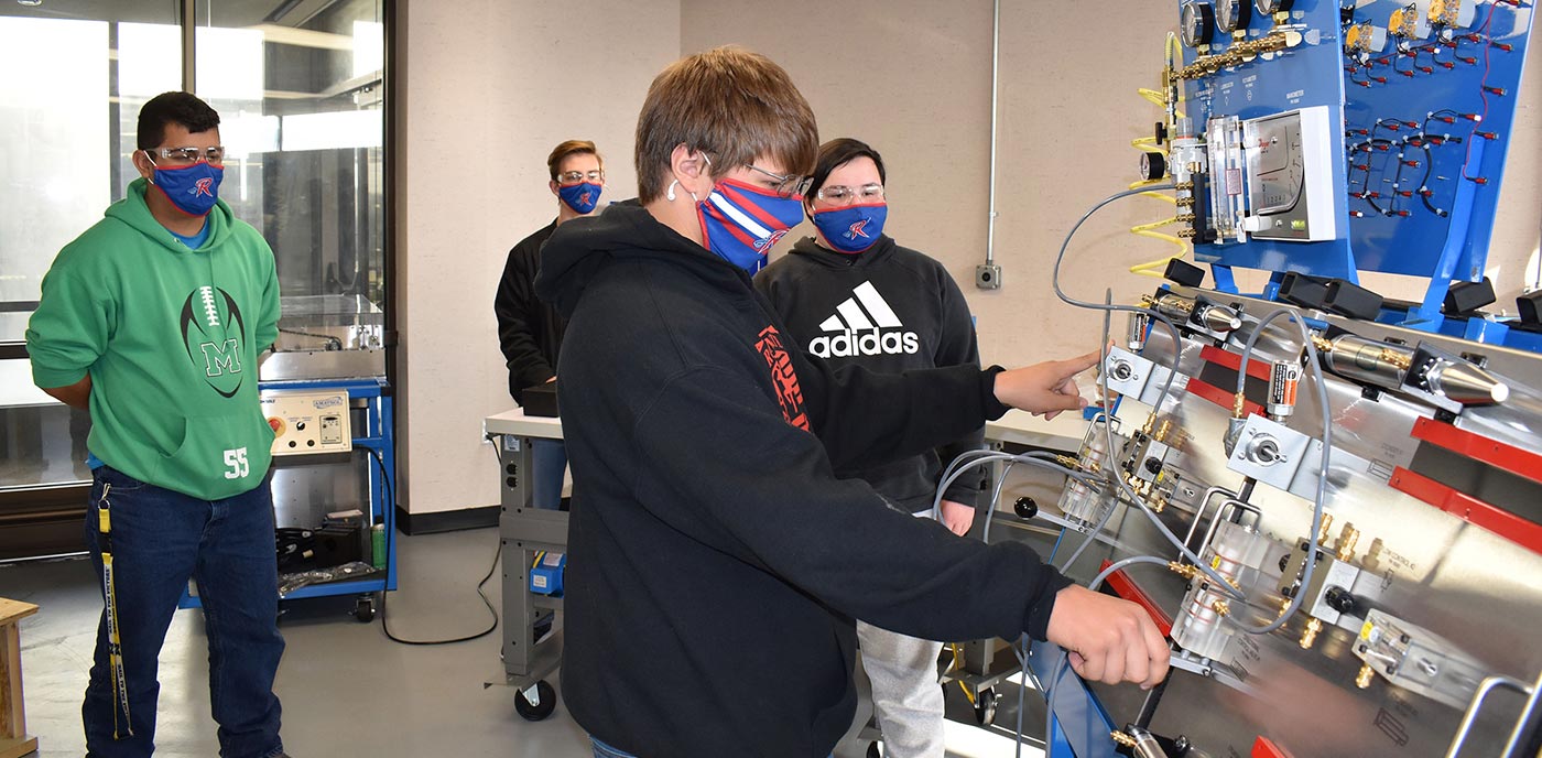Samual Watson of Wartburg Central High operates the pneumatic instrumentation module in Roane State’s new mechatronics lab on the Roane County campus. Watching in background, from left: Dylan Meza of Midway High, Cory Schwarze of Roane County High, and Micah Brewer of Wartburg Central.