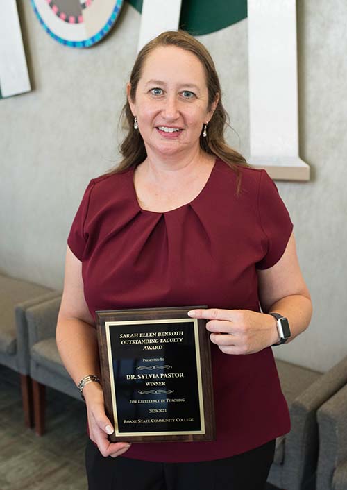 Dr. Sylvia Pastor holding award