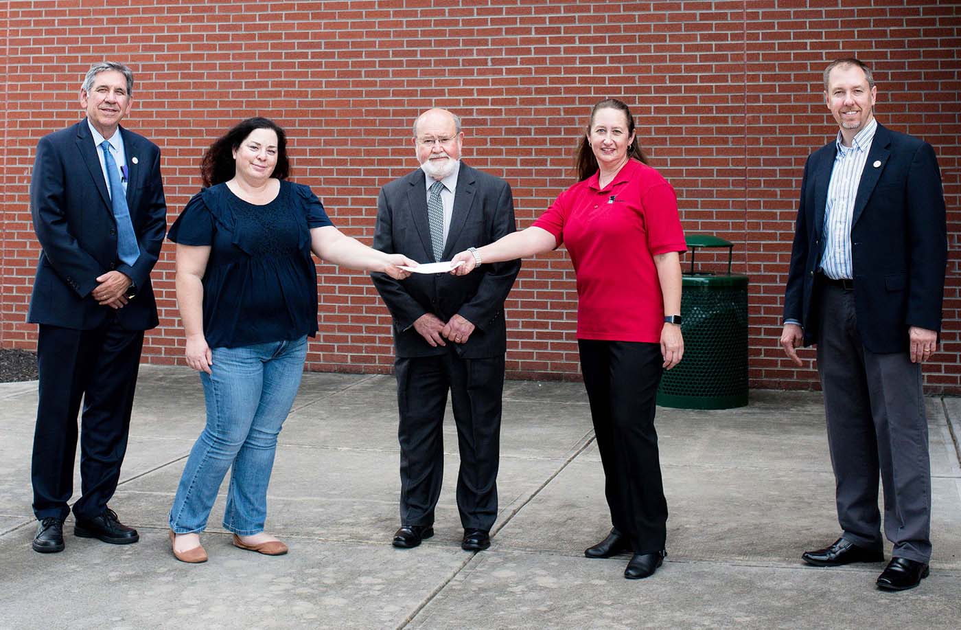 Jennifer Stone, scholarship chair for the Energy Technology and Environmental Business Association, hands a check from the trade association to Roane State Professor Dr. Sylvia Pastor, who oversees the community college’s involvement in the “Lab-In-A-Box” initiative. From left: Bill Moore, executive director of ETEBA; Stone; Barry Stephenson of Materials & Chemistry Laboratory Inc. and chairman of the Roane State Foundation Board of Directors; Dr. Pastor; and Scott Niermann, executive director of the Roane State Foundation.