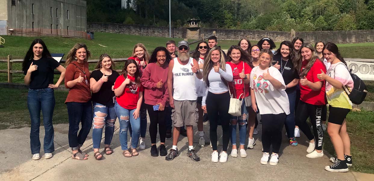 Students in Scott High School educator Lacey Massengale's dual enrollment class offered by Roane State are pictured at the former Brushy Mountain Penitentiary with their tour guide, a former inmate named George.