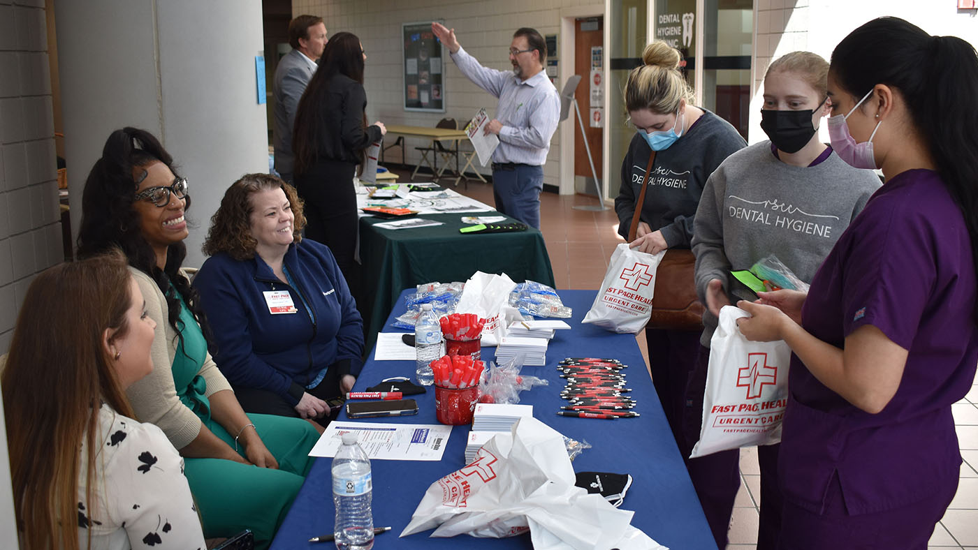 Roane State dental hygiene students check out the Fast Pace Urgent Care table during the community college’s Healthcare Job Fair, held in the Coffey-McNally Building on the Oak Ridge campus. Students, from left: Brooke Maxwell, Jessica Maples-Foster and Yesenia Izeta. Company representatives from left: Mendy Pevahouse, Ebony Richardson and Sharon Greenlaw.