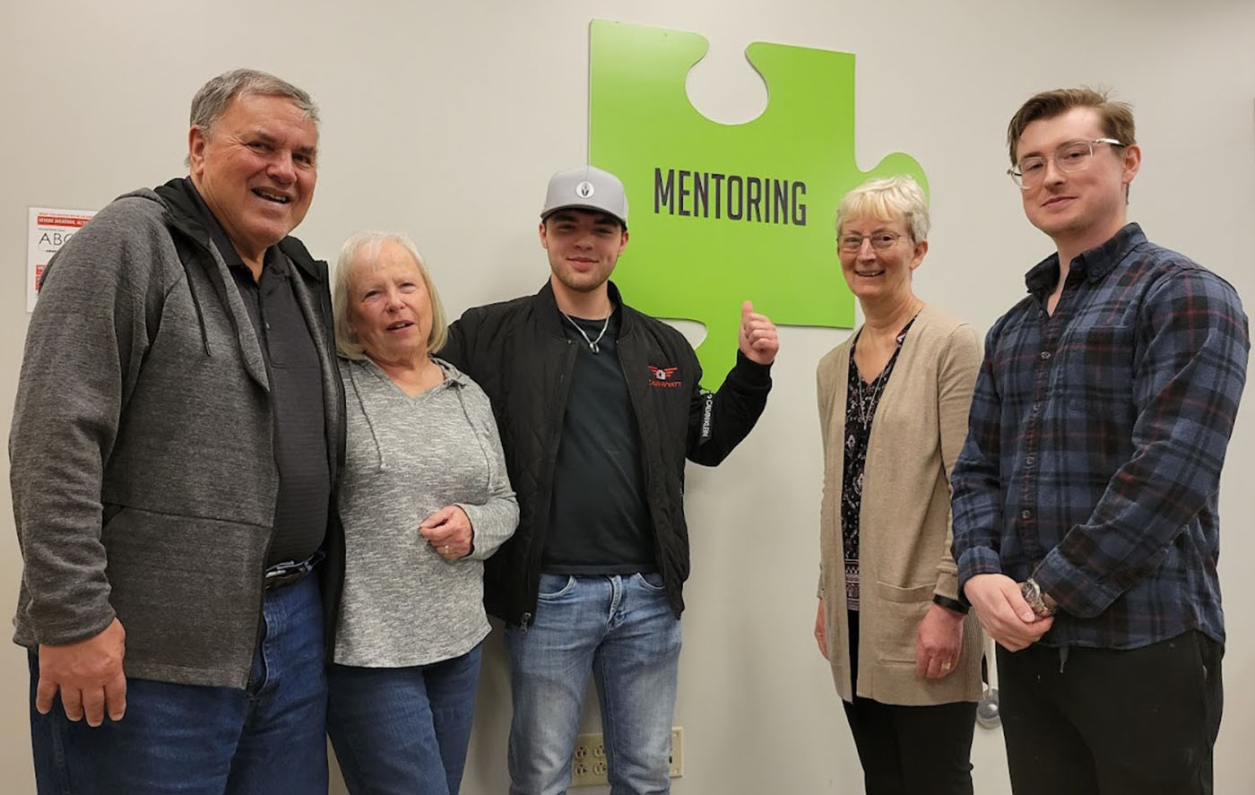 Pictured are Joe Swift (left) and his partner, Kathy Kendzior, who has assisted with the mentoring process as well as classroom sessions related to investing. Also shown are Calvin Wyatt (center), Holly Hanson, and Christian Heislop (far right).