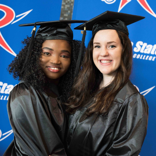 Two students pose for a photo prior to a recent Roane State graduation ceremony.