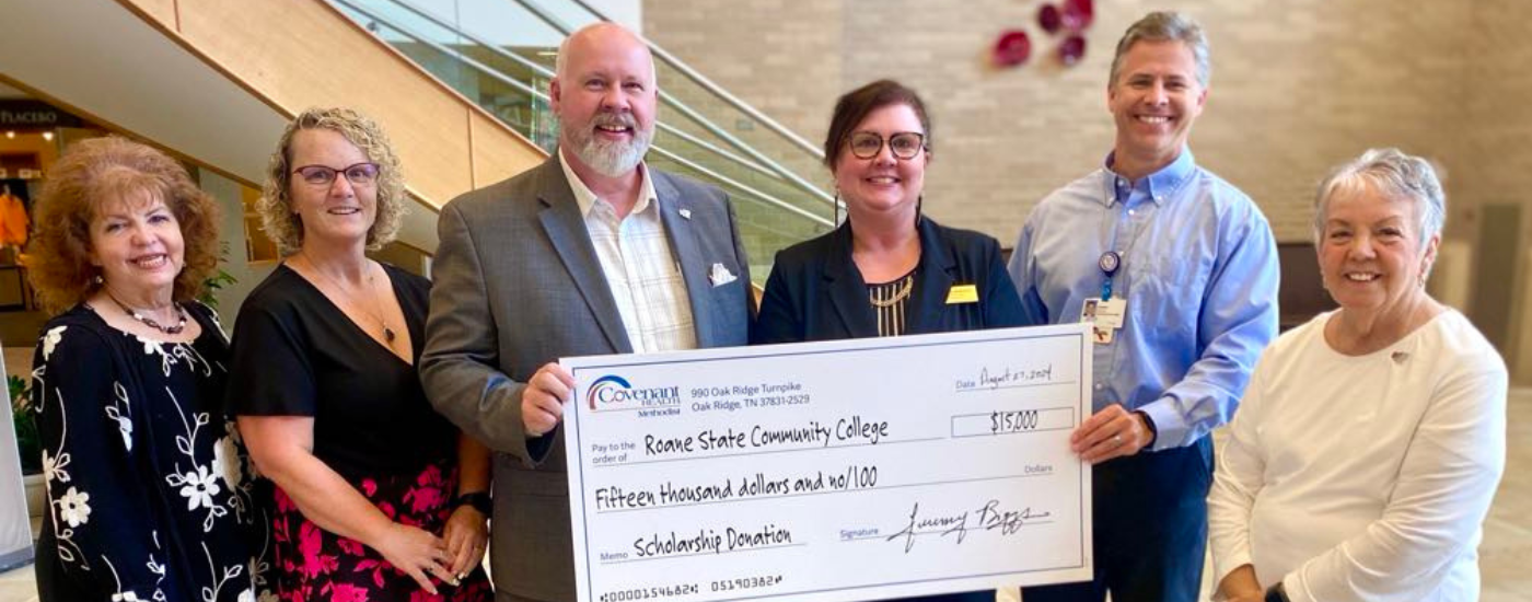 People holding a large check.