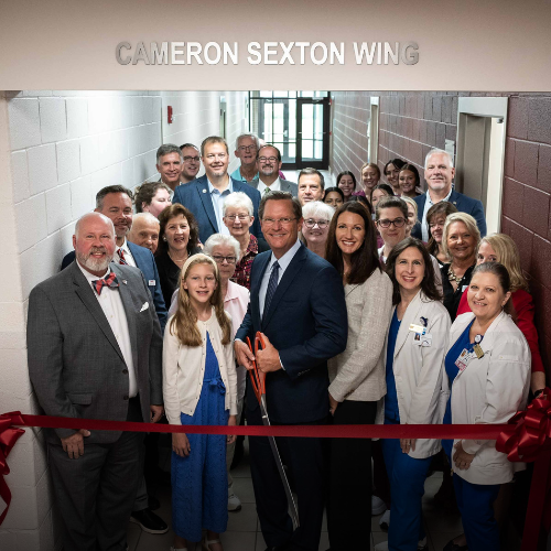 A ribbon cutting ceremony at a college campus.