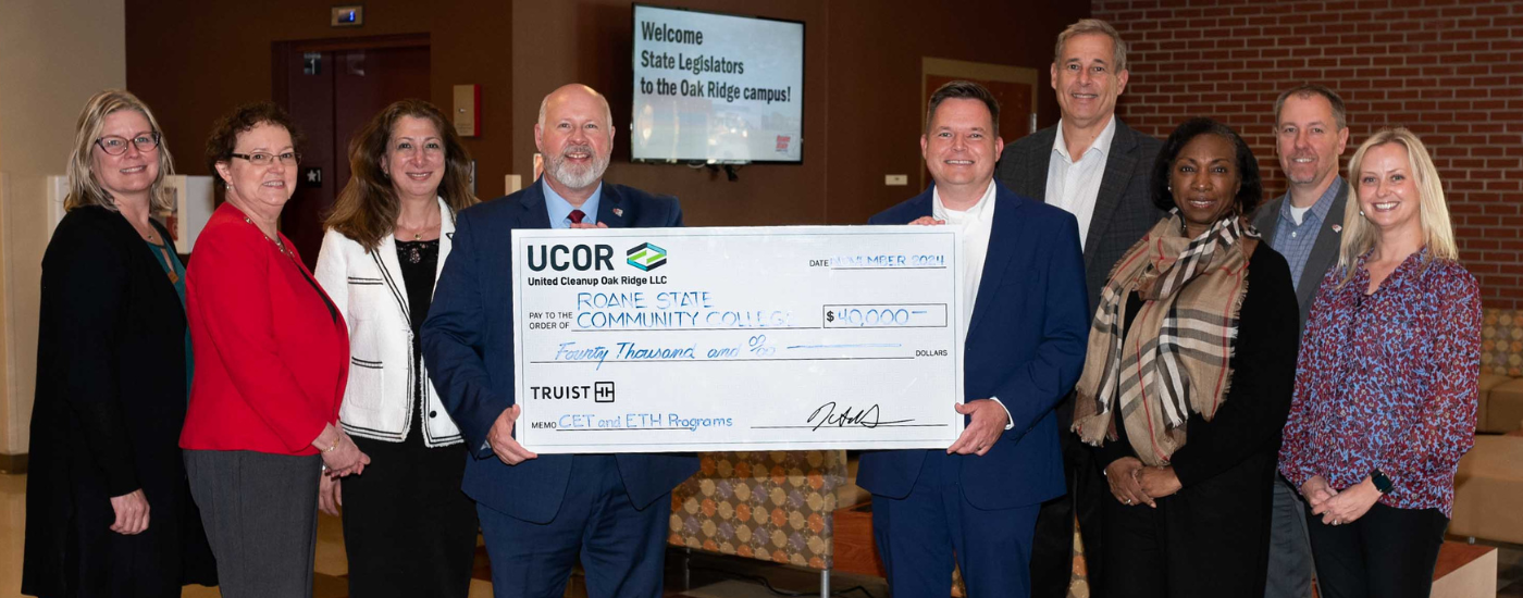 A group of people holding a large check.