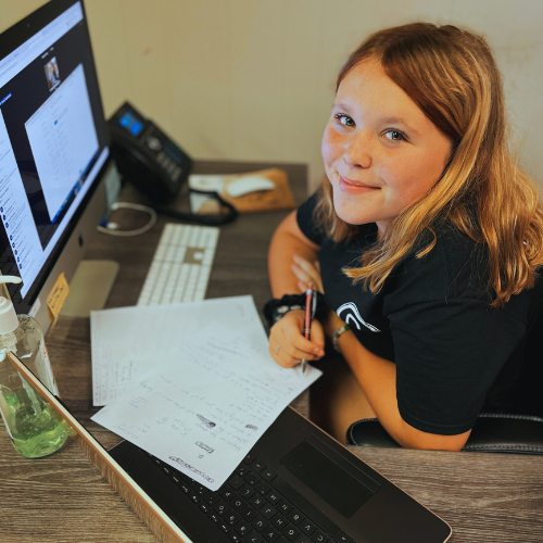 A young student working at a computer.