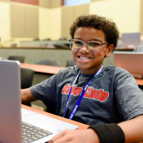 A student using a laptop in a classroom.