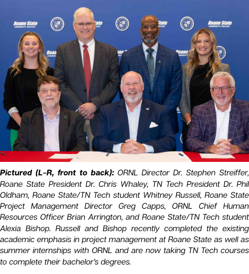 Seven people pose for a photo following the signing of an articulation agreement.