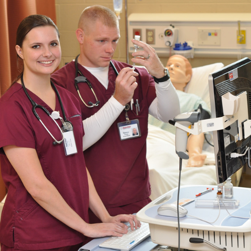 Nursing students practicing skills in a lab.