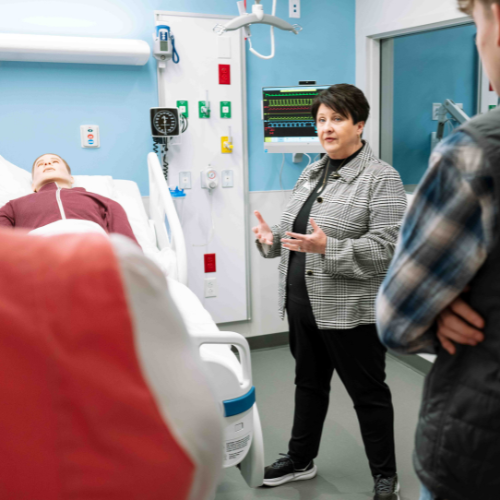 A simulation manikin in a hospital room.