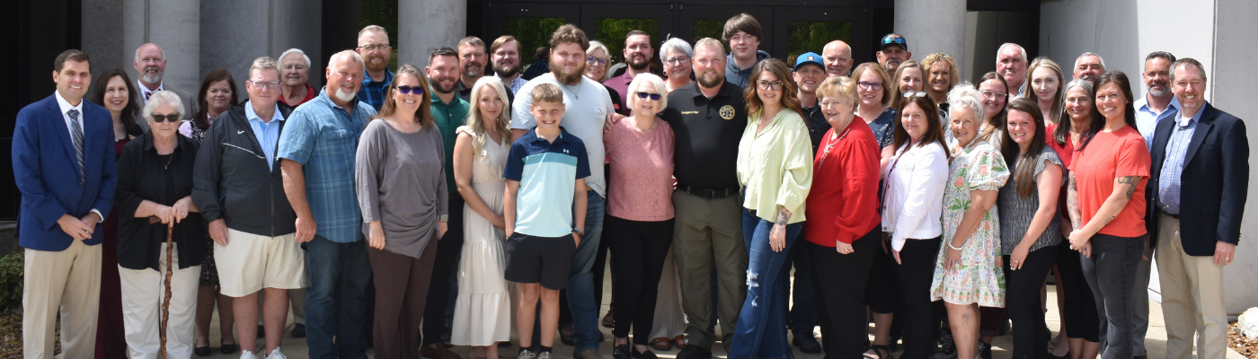 A large group of people pose for a photo in front of Roane State's Cumberland County Campus.