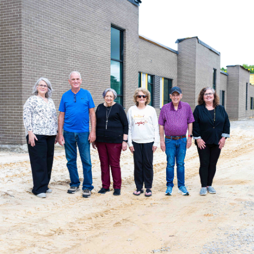 A group of people standing in front of the new campus in Fentress County while construction was still underway.
