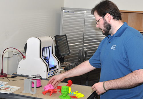 Jon Leasure examines products made with the 3-D printer inside the new Maker Space at the Cumberland Business Incubator.
