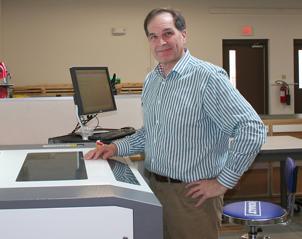 Tom McDunn, a Cumberland Business Incubator tenant and owner of TPM Technologies, uses a laser cutter that will be available in the incubator’s new Maker Space.