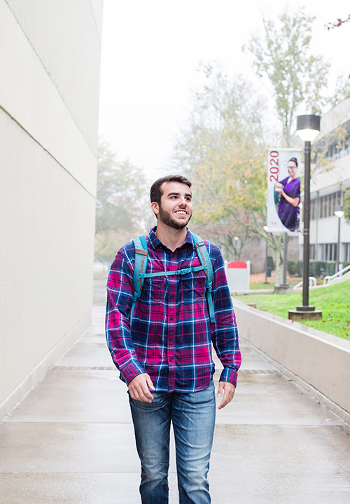 Student walking down sidewalk