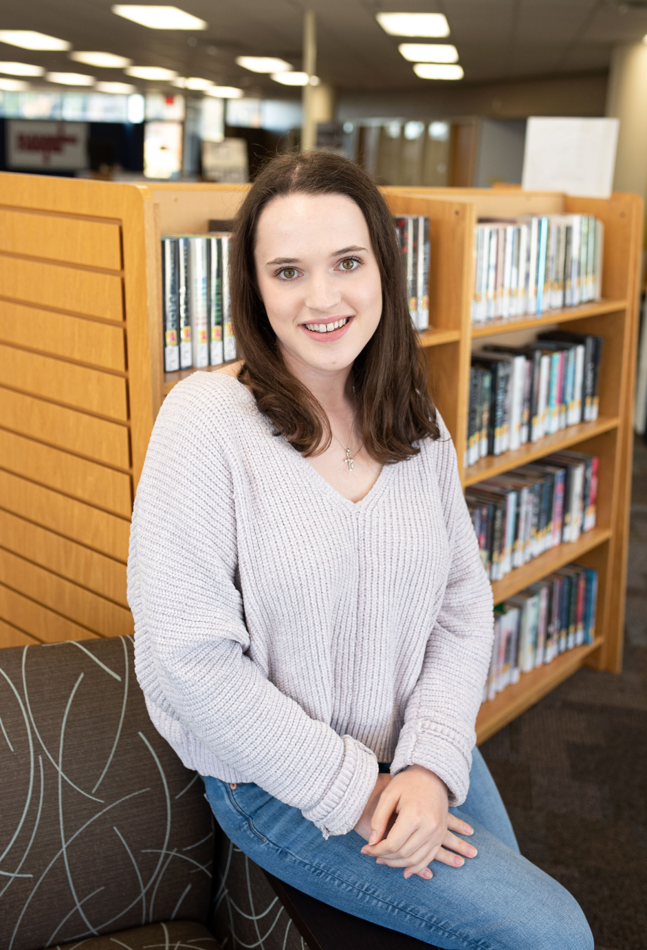 A student sitting in a library.