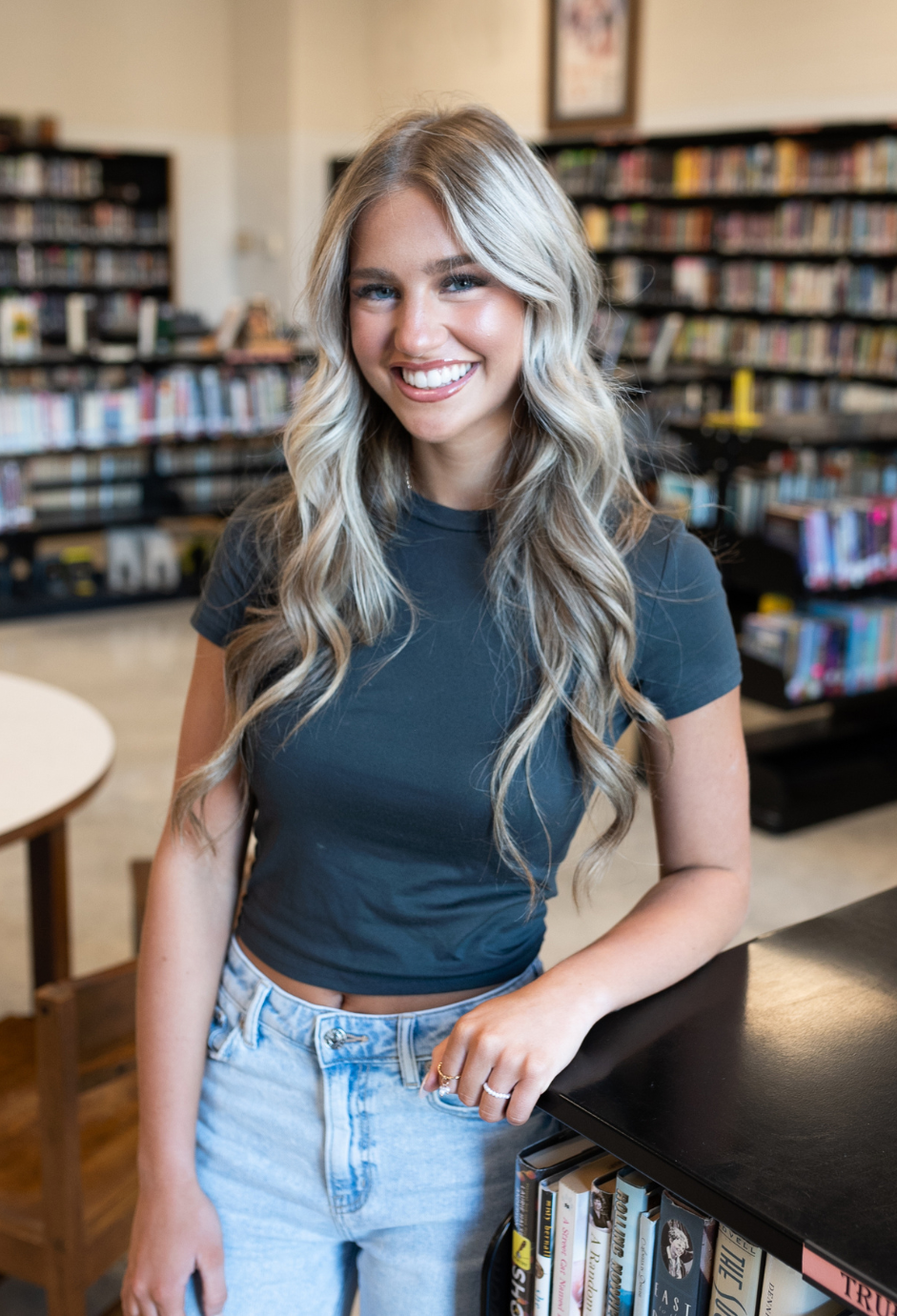 A student standing in a library.