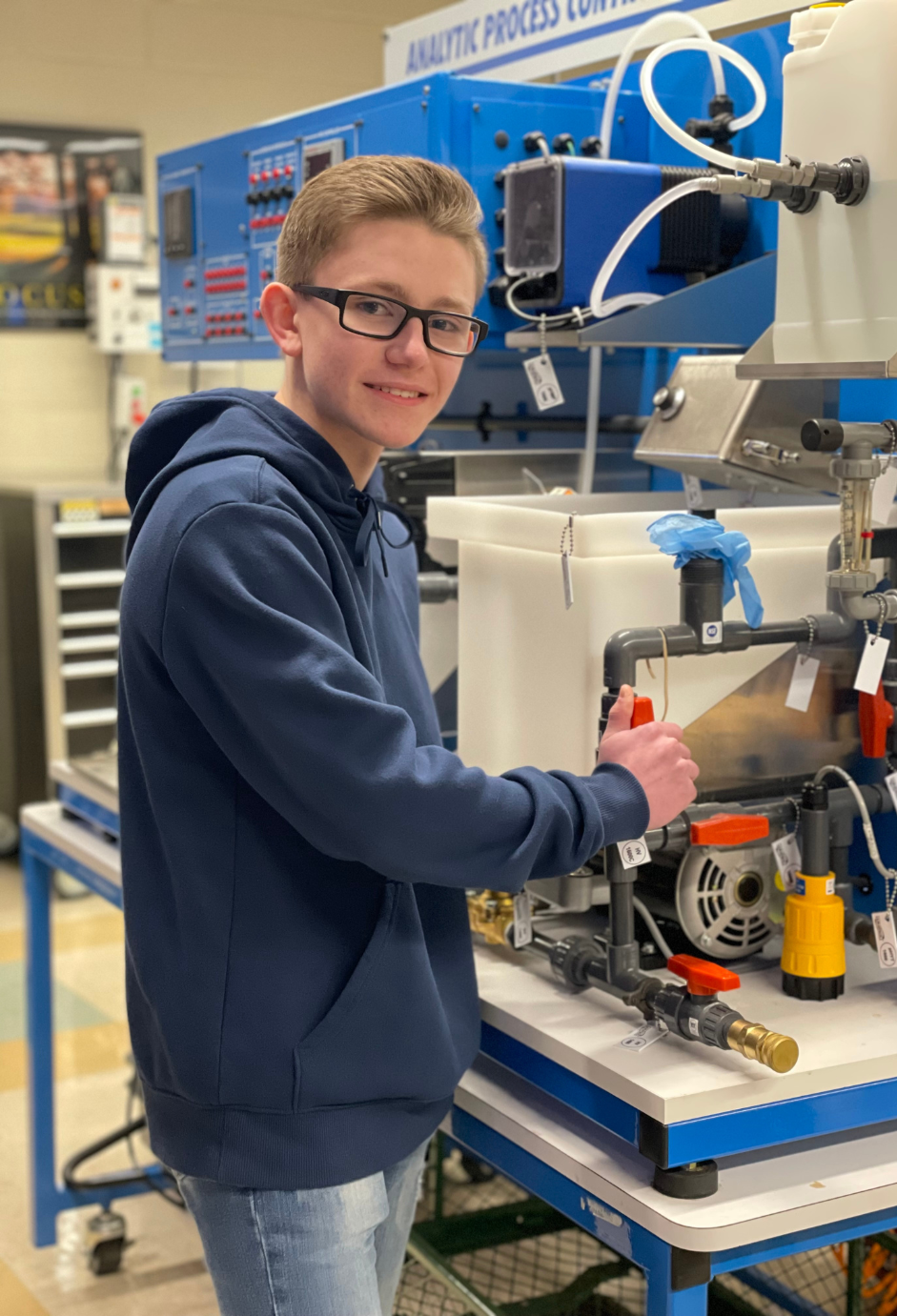 A student using engineering equipment in a lab.