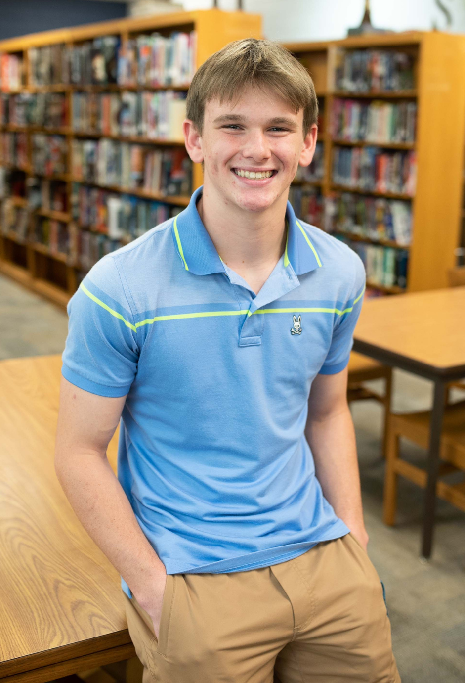 A student standing in a library.