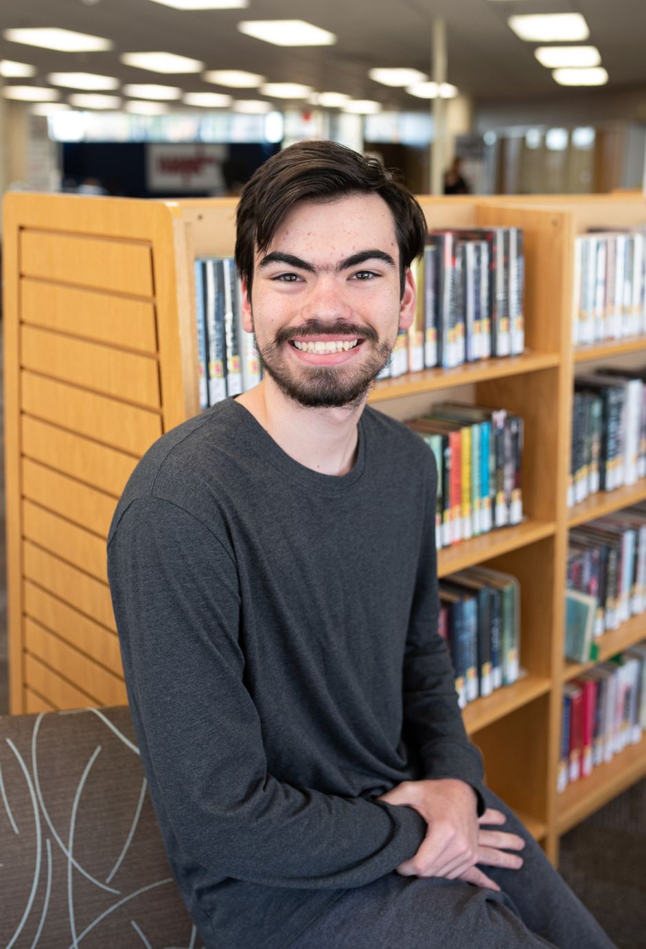 A student sitting in a library.