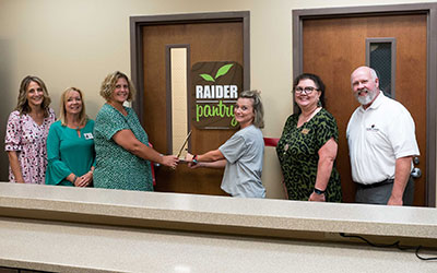 Roane State staff members cut the ribbon on the student food pantry at the Morgan County campus.